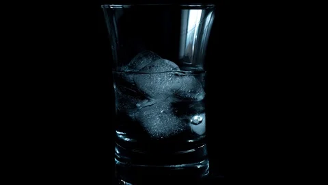 Time lapse of melting ice blue cubes in glass Stock Footage 130037565