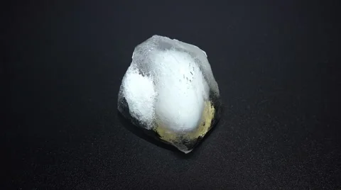 Time Lapse of Melting Ice Cube with Coin Inside Stock Footage 45430009