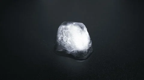 Time Lapse of Melting Ice Cube on black reflective background Stock Footage 45430400
