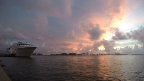 Time-lapse of Miami's Loading Cranes With Sunrise Peeking behind Ominous Clouds Stock-Footage 82587862