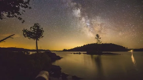 Time lapse milky way moving above an island on a lake in canada Stock Footage 79678352