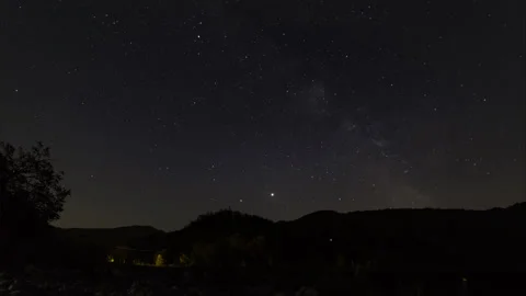 Time-lapse of the milky way over mountains with an highway Stock Footage 134035301