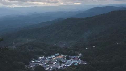 Time-lapse of mist and smoke drifted above a small village in the valley. Stock Footage 230062378