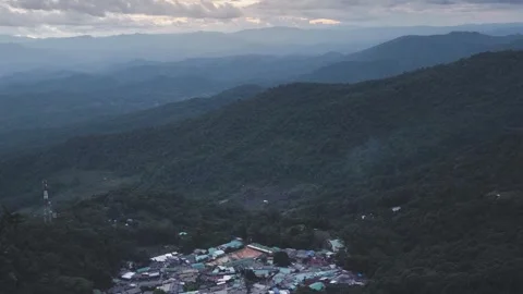 Time-lapse of mist and smoke drifted above a small village in the valley. Stock Footage 244538864