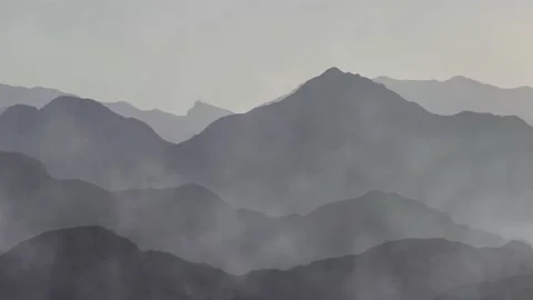 Time-lapse of mist clouds over mountain silhouettes 스톡 동영상 147696404