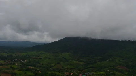Time lapse of mist floating over mountains with village on the foreground Stockbeeldmateriaal 92671748