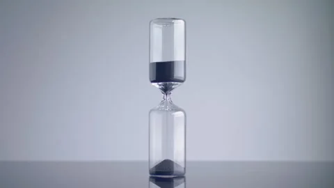 Time lapse of a modern design sand clock / hourglass on a grey background. Video stock 273114008