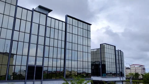 Time lapse Modern Office Building with Reflective Glass Facade under Cloudy Sky Stock Footage 304617103