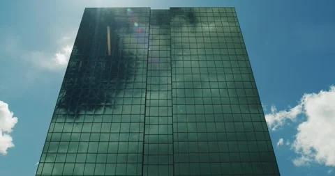 Time lapse Modern office high-rise skyscraper with clouds in the reflection Stock Footage 259071655