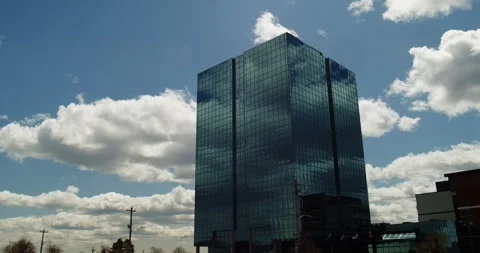 Time lapse Modern office high-rise skyscraper with clouds in the reflection Stock Footage 259072036