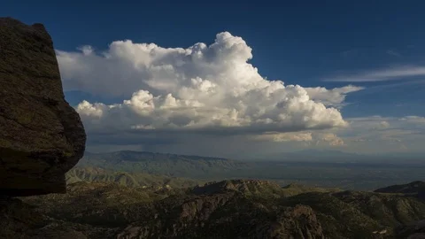 Time lapse of a monsoon thunderstorm beyond a massive rock hoodoo Stock Footage 78750340