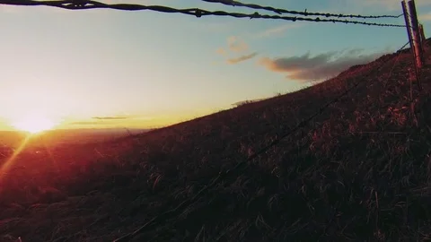 Time-lapse of Montana sunset with clouds behind fence Stock Footage 73051540