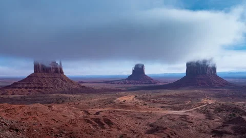 Time-lapse of Monument Valley Buttes with Fog and Clouds in Arizona Desert. Stock Footage 338390536