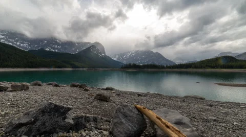 Time lapse of moody clouds over a mountain lake Stock Footage 68825215