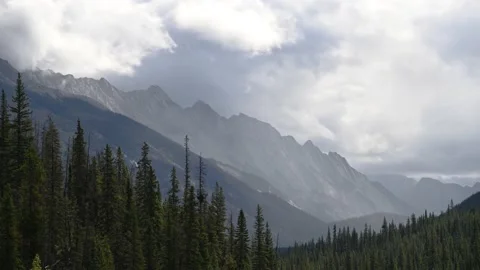 Time lapse of a moody scene of a rugged range of gray mountain peaks Stock Footage 141285144