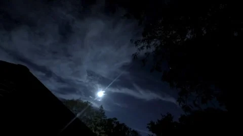 Time-lapse of Moon Emerging from Behind Clouds Stock Footage 346205159