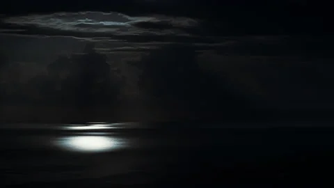 Time lapse. The moon moving across the sky clouds. Moonlight path on sea water 스톡 동영상 218683067