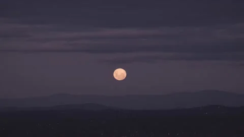 A time lapse of the moon rising over a mountain during dusk Stock Footage 232764416