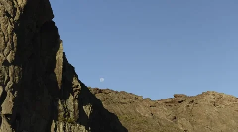 Time lapse of moon rising in sky behind mountains Stock Footage 63306737