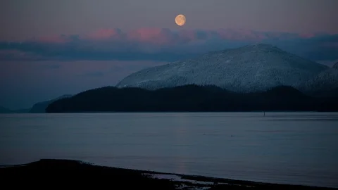 Time-lapse of moon set and sunrise over snowy mountains Stock Footage 113249586