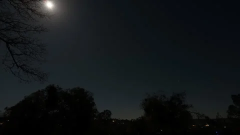 Time Lapse of Moon Set in Starry sky as Morning Lightfades to Clouds Stock Footage 278632130