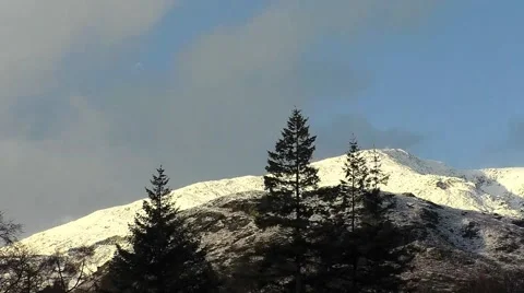 Time Lapse of Moon setting behind snow covered mountains    b00000b Stock Footage 45146081