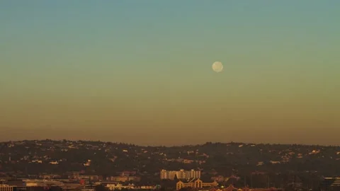 Time lapse Moon setting behind a ridge with air pollution Stock Footage 155386022