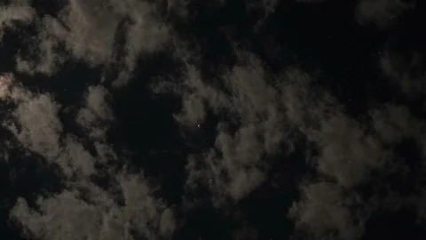 Time lapse of moonlit clouds forming at night with stars in the background Stock Footage 97120823