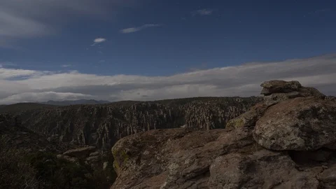 Time lapse of moonlit rock formations in a rugged canyon at night Stock Footage 119765407