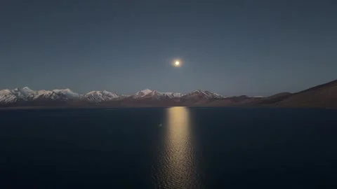 Time Lapse of Moonset and Golden Sunrise on Kula Kangri Over Puma Yumco Lake Stock Footage 332882298