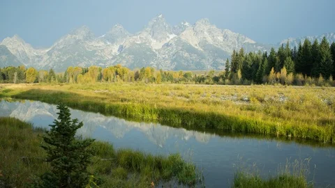 Time lapse of morning cloud shadows moving across snowy Grand Teton mountains Stock Footage 95621245