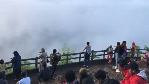 Time lapse: morning risers sit, talk, and enjoy the sunrise on the foggy hill Stock Footage 156307146