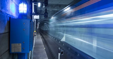 A time lapse of a motion blurred subway train travelling through an underground Stock Footage 98383412