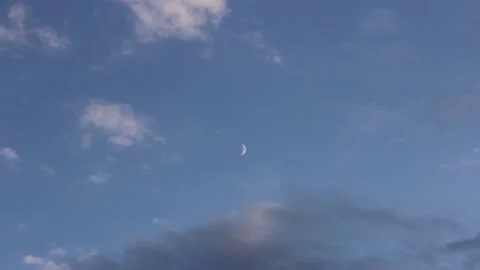 Time lapse motion of clouds around crescent moon during white nights Stock Footage 156002078
