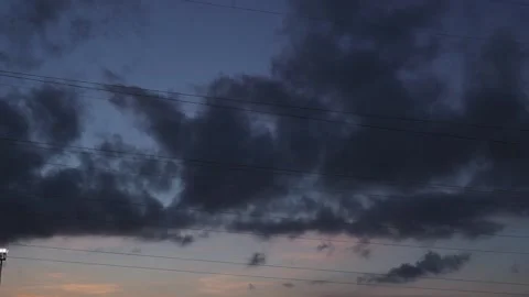 Time lapse motion of dark rain clouds in summer evening twilight blue sky Video stock 163185532