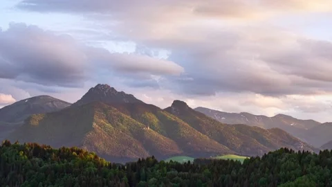 Time lapse motion of fast clouds over misty alps mountain peak in sunny spring Stock Footage 201165802