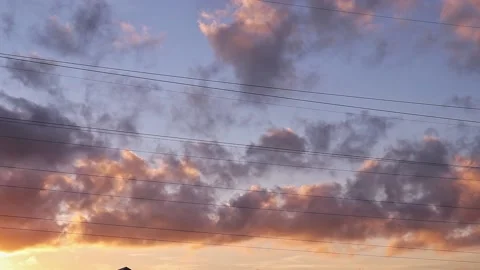 Time lapse motion of orange clouds in summer sunset sky on warm evening twilight Stockbeeldmateriaal 163185542