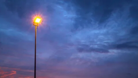 Time lapse motion of Street light that illuminates the sunset light 動画素材 130096655