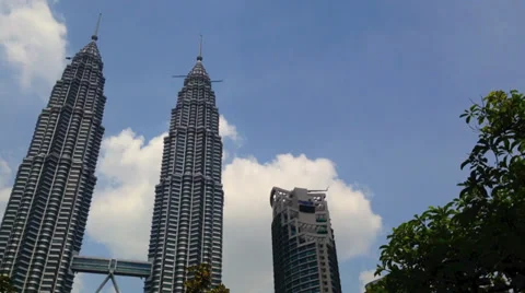 Time lapse in motion view of clouds swirling around the Petronas Twin Towers Stock Footage 39230320
