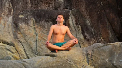 Time lapse in motion of young man sitting in meditation Video stock 37118091