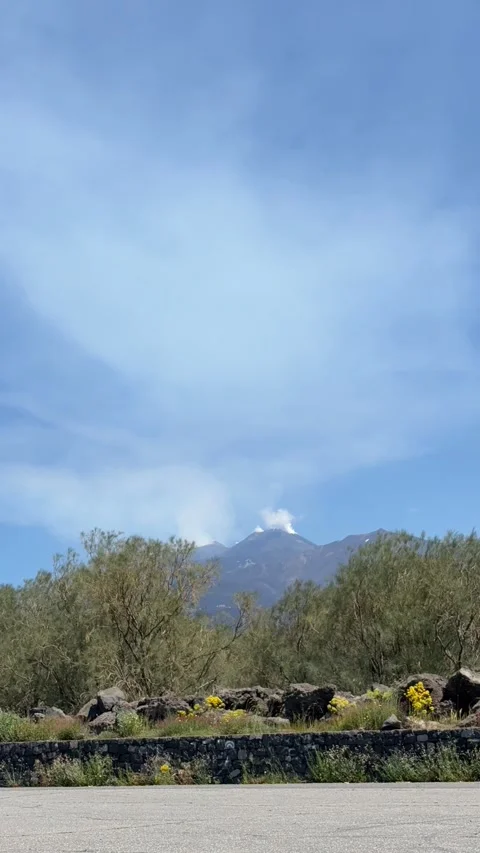 A time-lapse of Mount Etna emitting smoke. Vertical edition Stock Footage 309459868