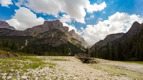 Time lapse of mountain, clouds, river and bridge. Video stock 64970556