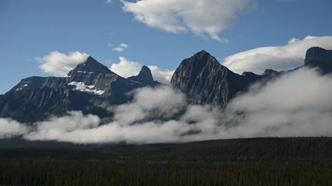 Time lapse of a mountain landscape with low clouds moving through a valley  Stock Footage 247412425