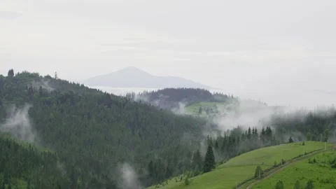 Time-lapse mountain range covered with rolling rainy clouds. Cloudy summer day Stock Footage 304705194