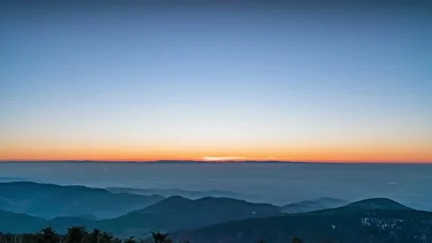Time-lapse of mountains and distant city at sunset, day to night Stock Footage 147307558