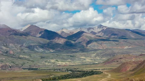 Time-lapse in the mountains: clouds rush across sky, shadows across landscape Video stock 157019956