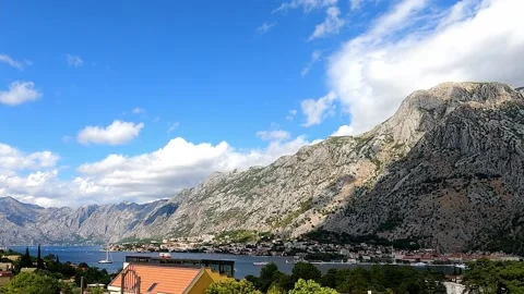 Time-lapse, the movement of clouds across the blue sky over the Bay of Kotor Stockbeeldmateriaal 160729405