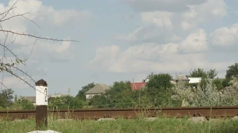 Time lapse of the movement of white clouds over the old railway rails agains Stock Footage 205100430