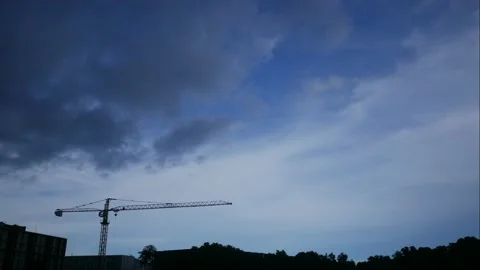 Time lapse of moving  cloud with blue sky. Silhouette crane, building and tre Stock Footage 131924061