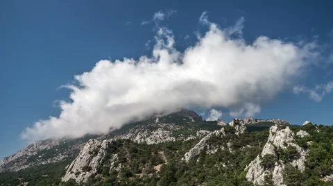 Time-lapse of moving clouds above a mountain Stock Footage 55169908